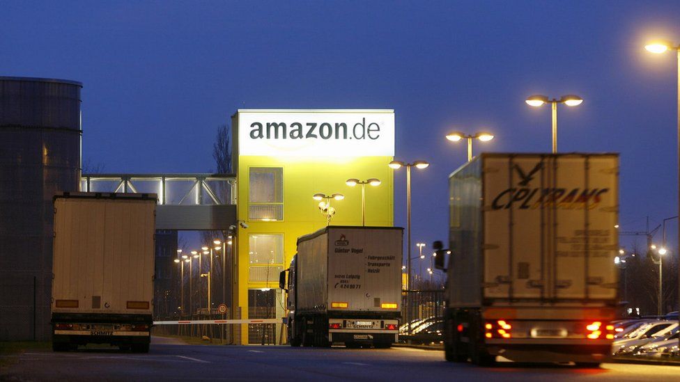 Trucks drive into the online retailer Amazon's distribution centre in the eastern German city of Leipzig
