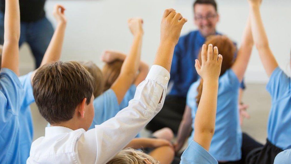 Secondary pupils raise hands