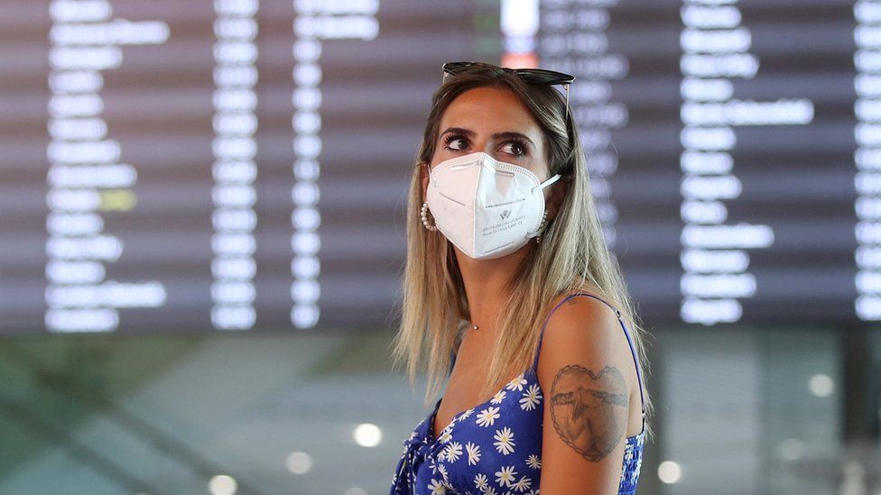A tourist wearing a face mask waits at Split International Airport in Croatia, 21 August 2020