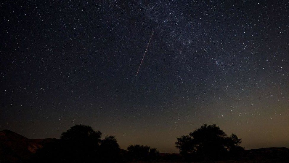 Perseid meteor streaks across the sky above a camping site in the Israel Negev desert