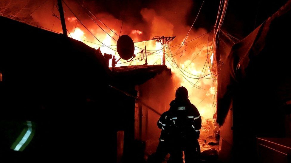 Firefighters work to put out a fire in a Seoul slum