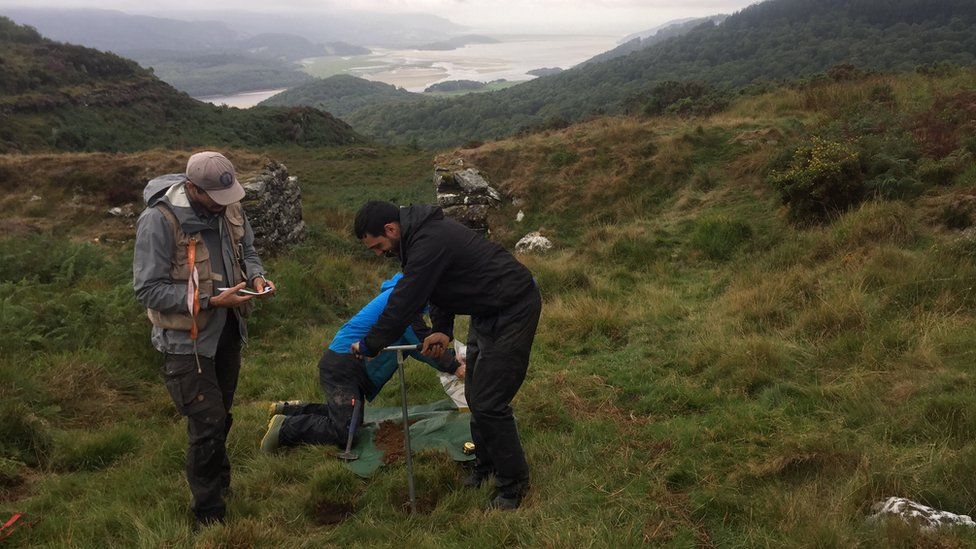 Soil samples being taken on Welsh hillside