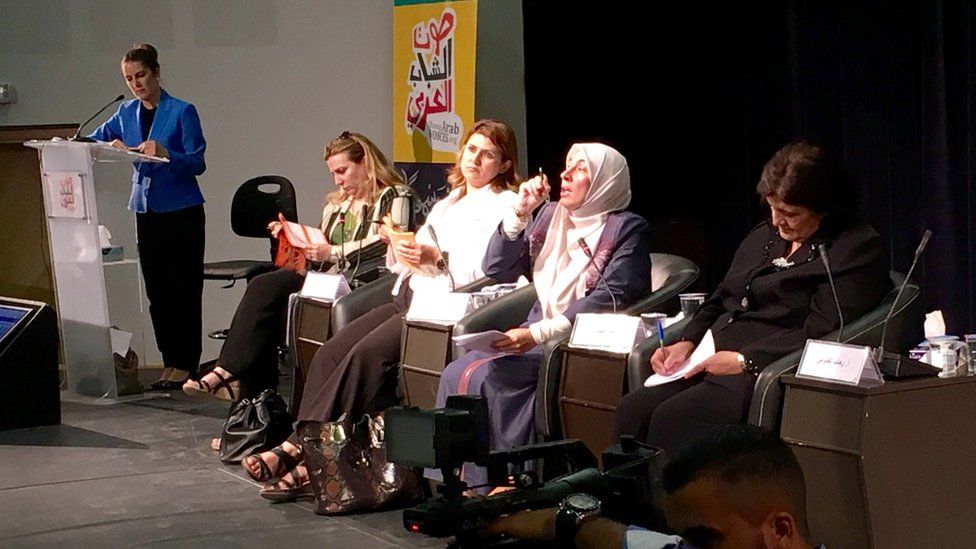 Dima Tahboub (seated, talking)