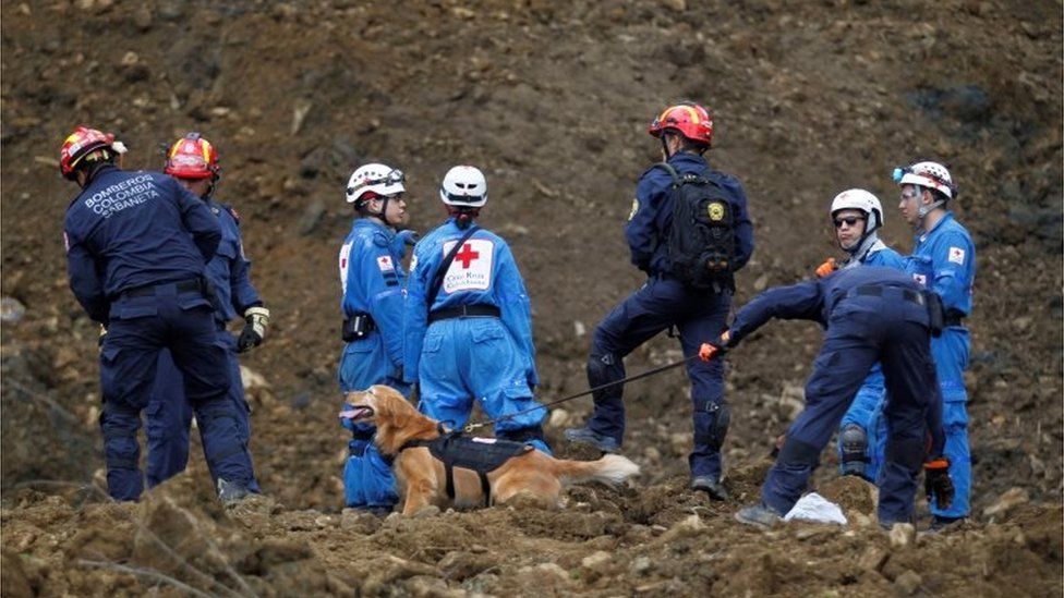 Rescuers search for survivors or victims of a landslide that affected the Medellin-Bogota highway in Colombia October 26, 2016.