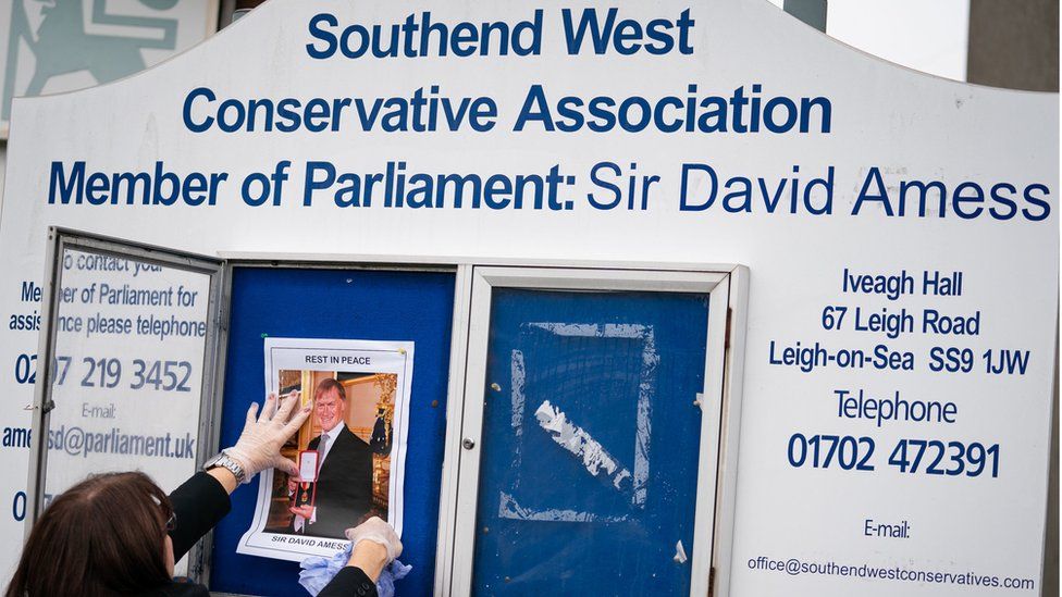 A photograph of Sir David Amess is placed on a noticeboard outside the Iveagh Hall, the home of the Southend West Conservative Association in Leigh-on-Sea, Essex.