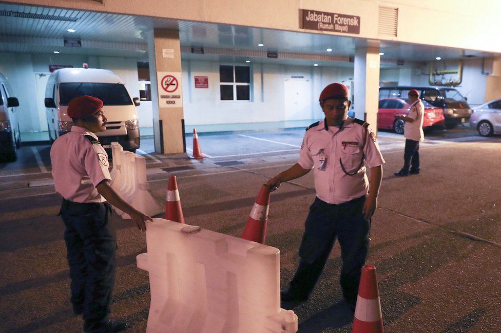 Hospital security personnel block the entrance of the forensic department at a hospital in Putrajaya, Malaysia, 14 February