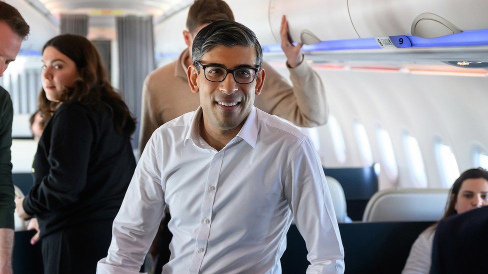 Rishi Sunak speaking to the press during his flight to San Diego for meetings with US President Joe Biden