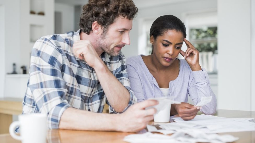 Couple looking astatine  a bill