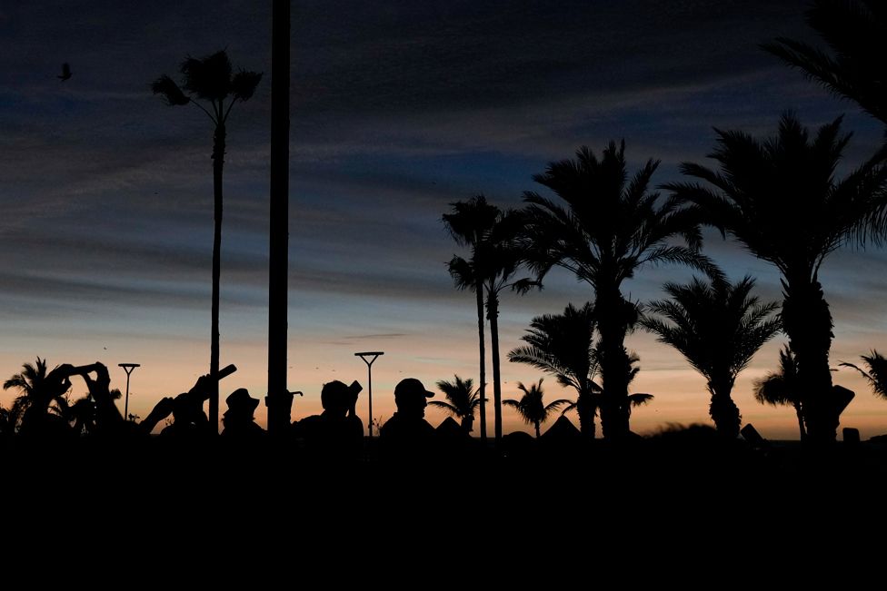 People watch a total solar eclipse as the sky goes dark in Mazatlan, Mexico, Monday, April 8, 2024.