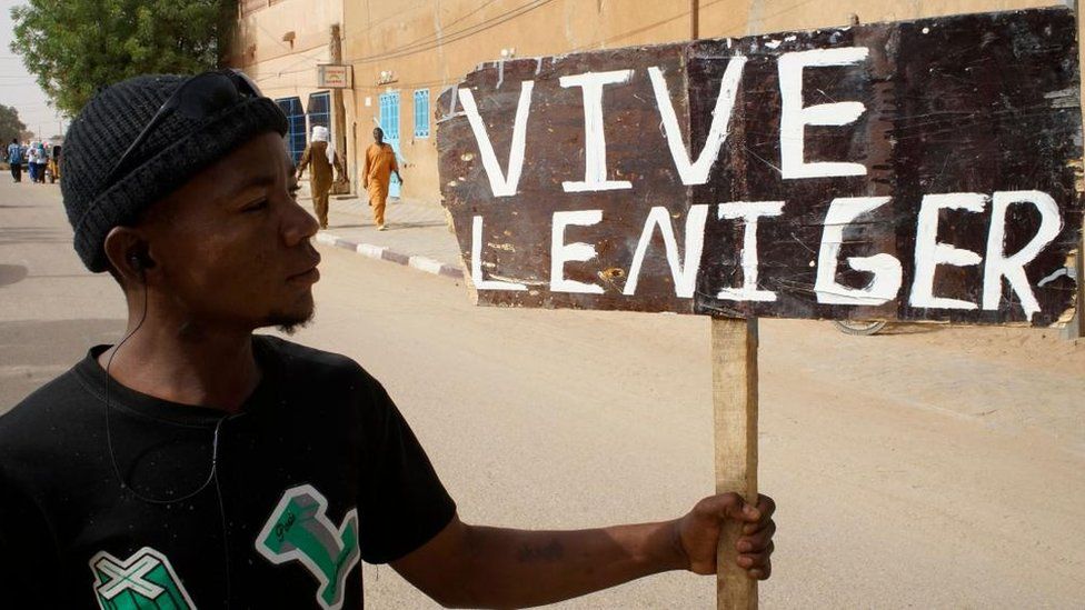 A demonstrator holds a placard reading 'Long live Niger' during a protest rally to demand the withdrawal of US troops from Niger, in Agadez, Niger, 21 April 2024