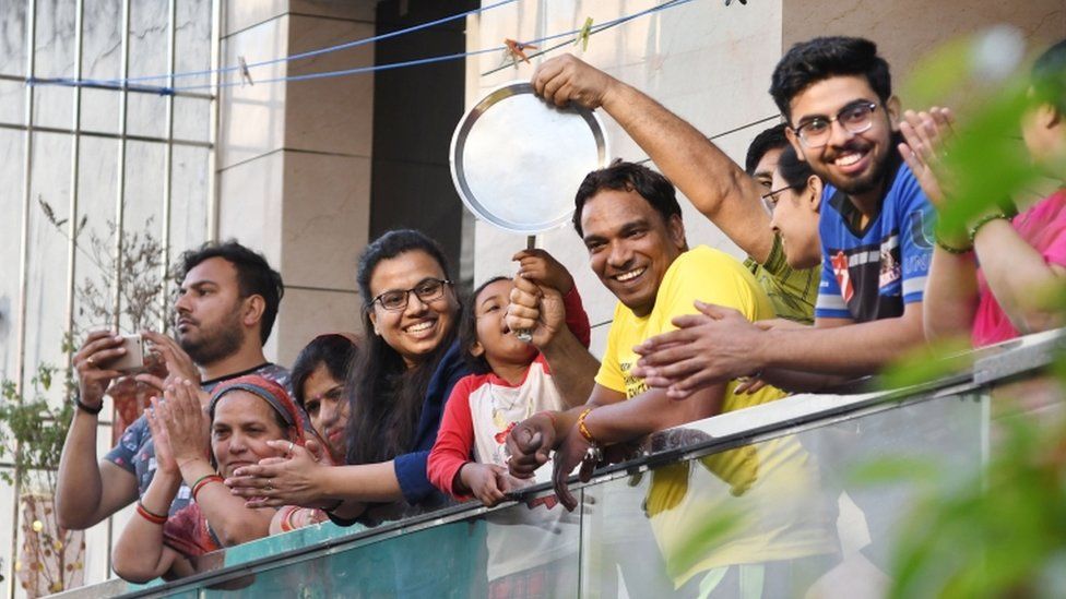 Indians bang utensils and clap from their balconies in New Delhi, India, 22 March 2020.