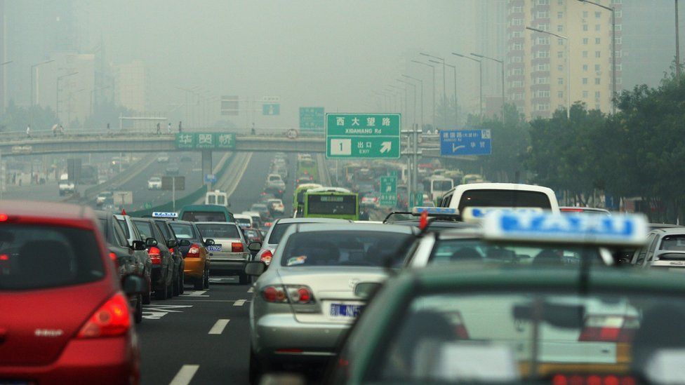 Heavy air pollution above cars driving in Beijing