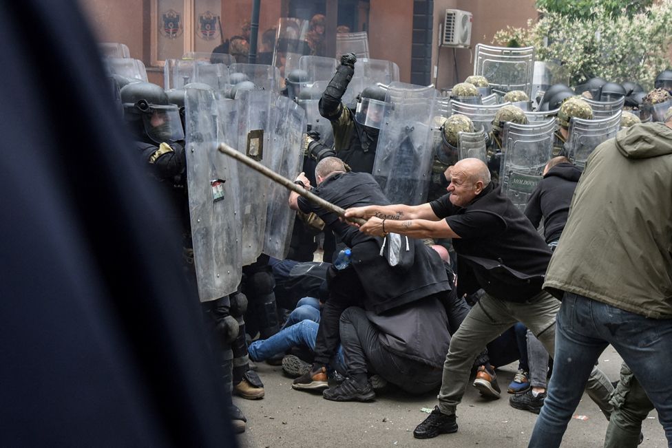 NATO Kosovo Force (KFOR) soldiers clash with local Kosovo Serb protesters at the entrance of the municipality office, in the town of Zvecan, Kosovo, May 29, 2023.