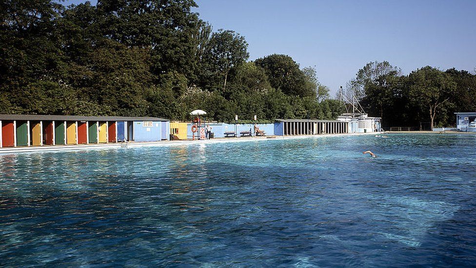 A person swims in the lido on a summer's day
