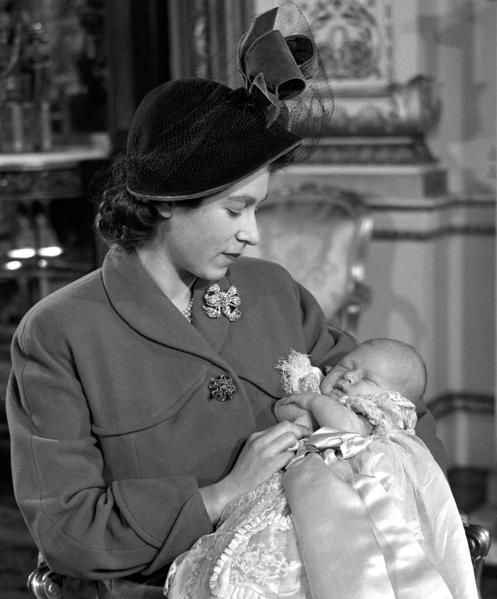 Princess Elizabeth holds her son Prince Charles after his Christening ceremony in Buckingham Palace, 1948
