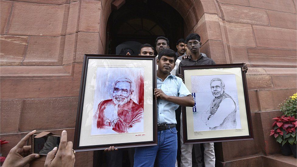 Narendra Modi supporters from puducherry display a sketch of the The Prime Minister painted using blood at the Parliament on December 1, 2016 in New Delhi, India.