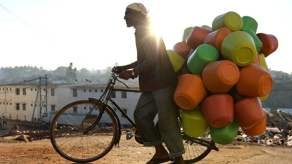 This photo taken in March 2015 shows a vendor carrying colourful plastic water pots on his bicycle to sell to households in Bangalore.
