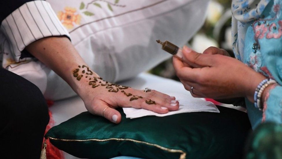 Meghan getting henna tattoo