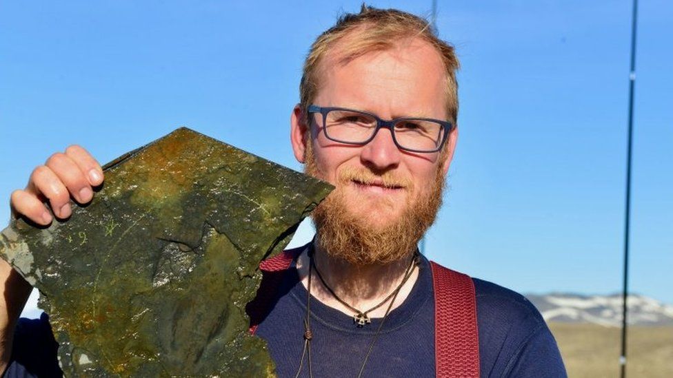 Scientist Dr Jakob Vinther holding up a fossil remain
