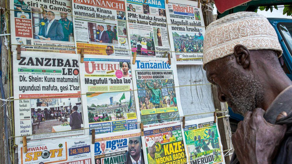 A man reads newspapers at a kiosk in Zanzibar's town on October 24, 2020