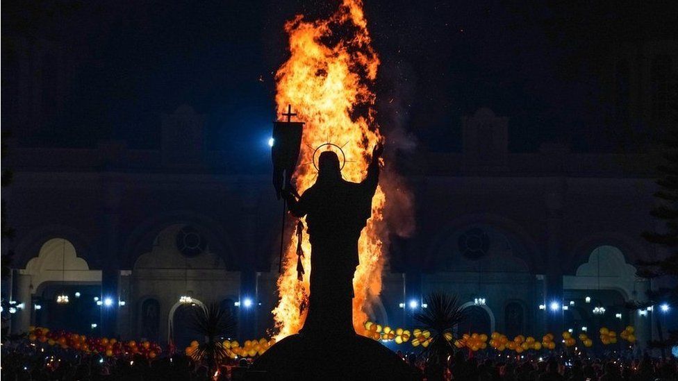 A blaze in front of a statue of Jesus Christ during the annual Meskel celebration at Bole Medhane Alem Church in Addis Ababa, Ethiopia - 26 September 2021