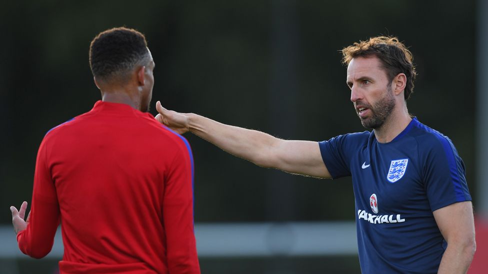 Gareth Southgate speaks to Brendan Galloway during the U21 training session at St Georges Park on September 2, 2016 in Burton-upon-Trent, England.