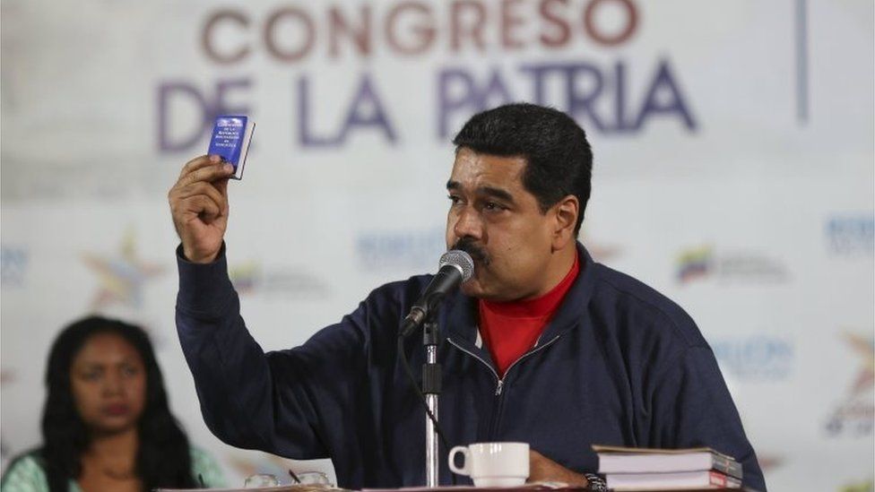 Venezuela"s President Nicolas Maduro (C) holds a copy of the country's constitution while he talks to supporters during an event at the 4F military fort in Caracas, in this handout picture provided by Miraflores Palace on January 23, 2016. REUTERS/Miraflores Palace/Handout via Reuters