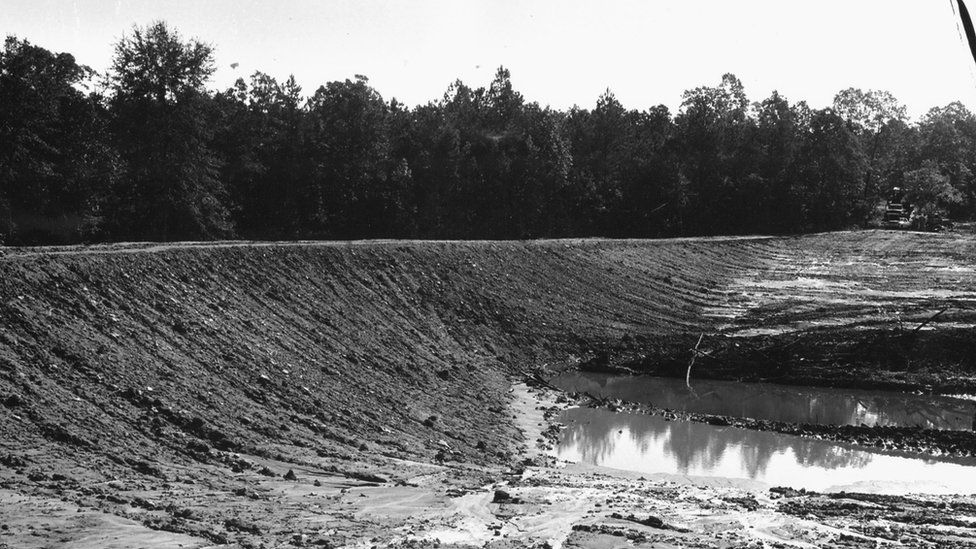 A black and white FBI photograph of the dam where the bodies were unconvered