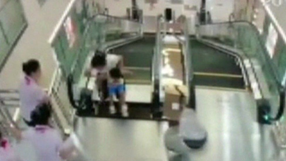 Surveillance video showing the woman and child on the escalator, provided by CCTV to Reuters, 26 July 2015