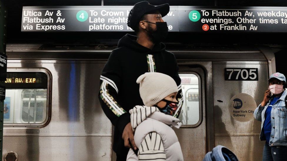 People walk through a Brooklyn subway station