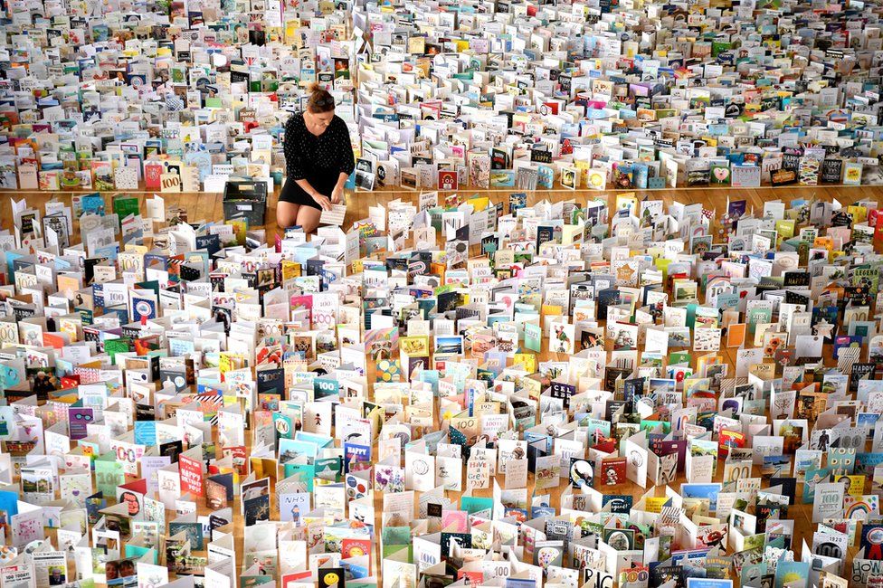 A view of thousands of birthday cards laid out in a large hall