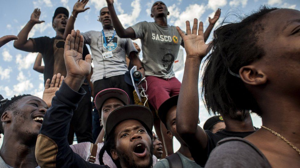 Students cheer after the Cecil Rhodes statue was removed from the University of Cape Town in South Africa on 9 April 2015
