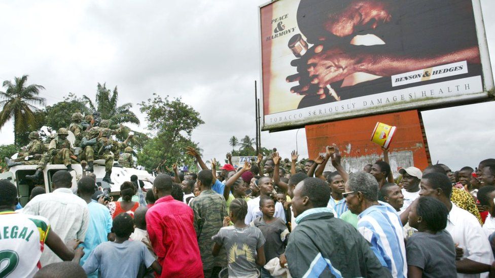 Nigerian peacekeepers wade through cheering crowds of Liberians as they make their first rounds through the center of Monrovia August 7, 2003 in Monrovia, Liberia. Jubilant Liberians met the peacekeepers all along a patrol through the capital, cheering the arrival of troops to help end the Liberian civil war.