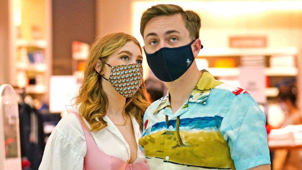 Two shoppers wearing facemasks inside a shopping centre in east London, 4 July 2021