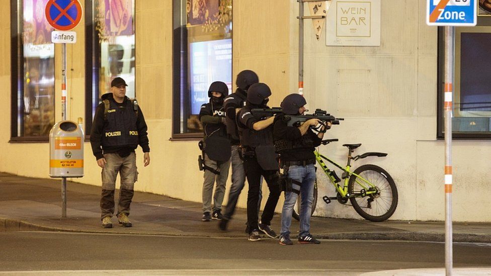 Police officers aim their weapons on the corner of a street after exchanges of gunfire in Vienna, Austria November 2, 202