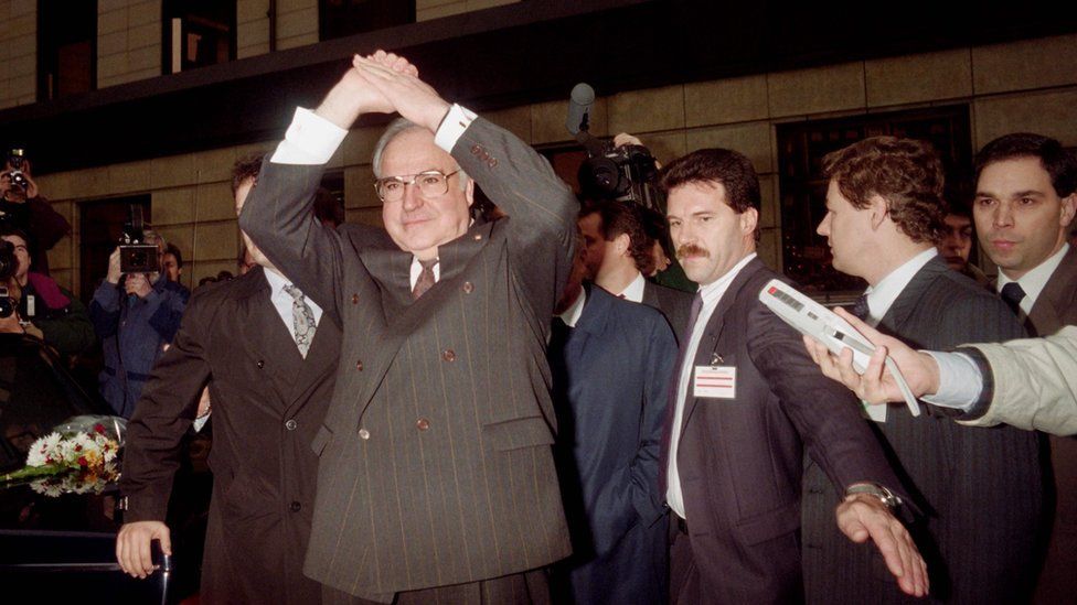 West German Chancellor Helmut Kohl (L) waving the crowd after a meeting with East German Prime Minister Hans Modrow in Dresden