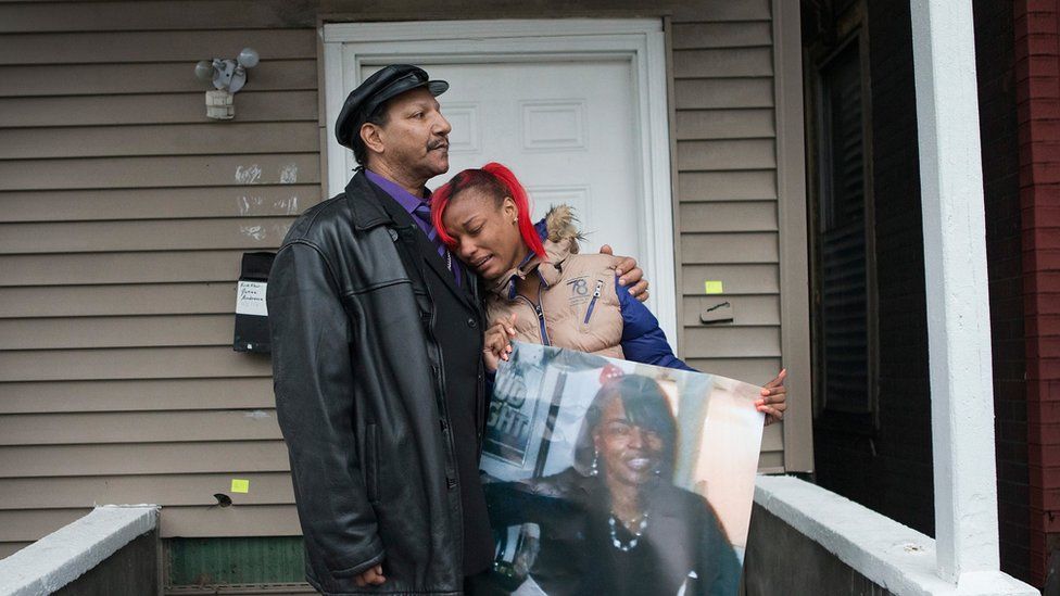 LaTonya Jones, the daughter of Bettie Jones, gets comfort from her father Garry Mullen during a vigil to honour Bettie, a 55-year-old mother of 5, on December 27, 2015 in Chicago, Illinois.