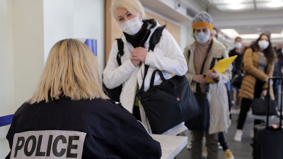 A French border police officer controls passengers as they arrive at Nice Cote d'Azur Airport amid the coronavirus disease (COVID-19) outbreak in Nice, France, March 1, 2021