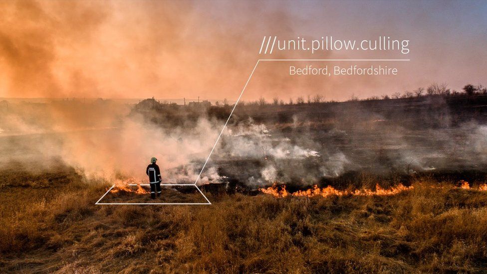 Firefighter at fire with what3words grid showing location name