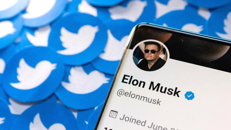 Elon Musk's Twitter profile is seen on a smartphone placed on printed Twitter logos in this picture illustration taken April 28, 2022.