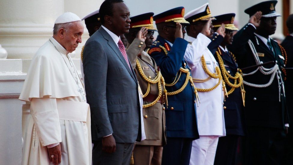 Pope Francis (L) and President Uhuru Kenyatta (2-L) standing for a national anthem, upon his arrival at the State House in Nairobi, Kenya, 25 November 2015