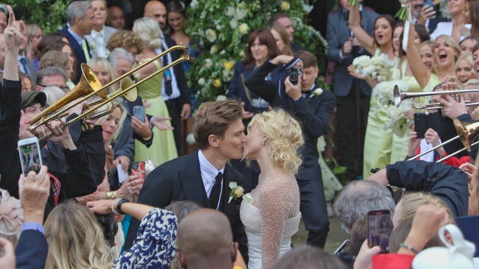Pixie Lott and Oliver Cheshire kissing after their wedding