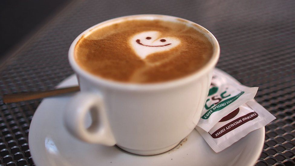 A smiley face and heart adorn the froth of a cappuccino (stock image)