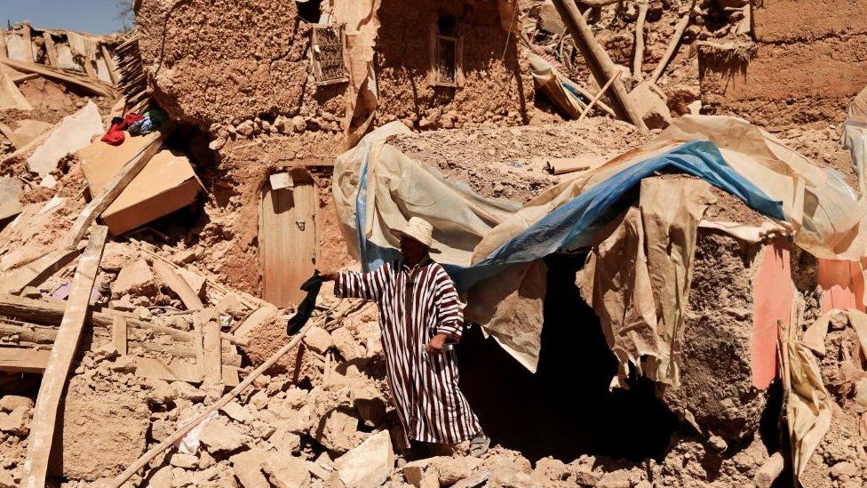 Mohamed Ouchen, 66, a survivor, who helped to pull his sister and her husband with their children from rubble, stands near his destroyed house, in the aftermath of a deadly earthquake, in Tikekhte, near Adassil, Morocco, September 11,