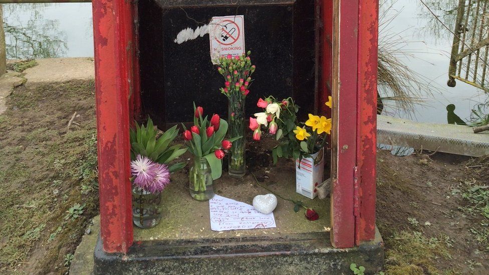 Floral tributes in the phone box
