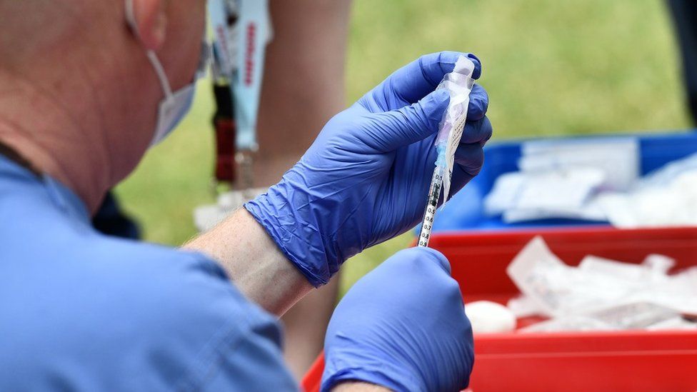 A medical professional prepares a vaccine at a walk-in Covid-19 vaccination clinic at Belfast City Hall