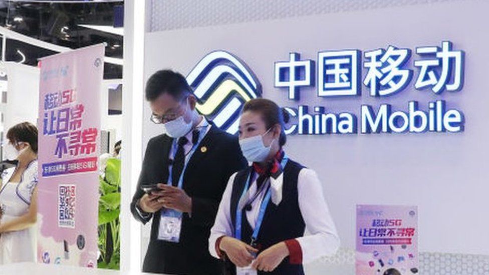 People visit the stand of China Mobile Communications Group.