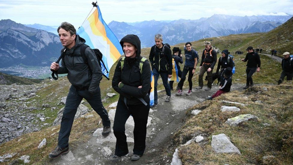 People take part in a funeral march for a glacier lost to global warming