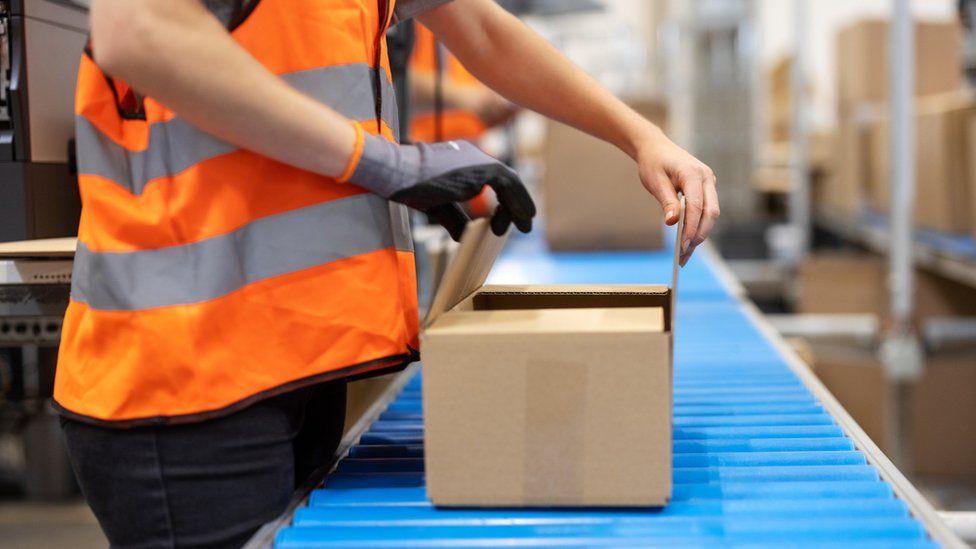 Woman on parcel production line