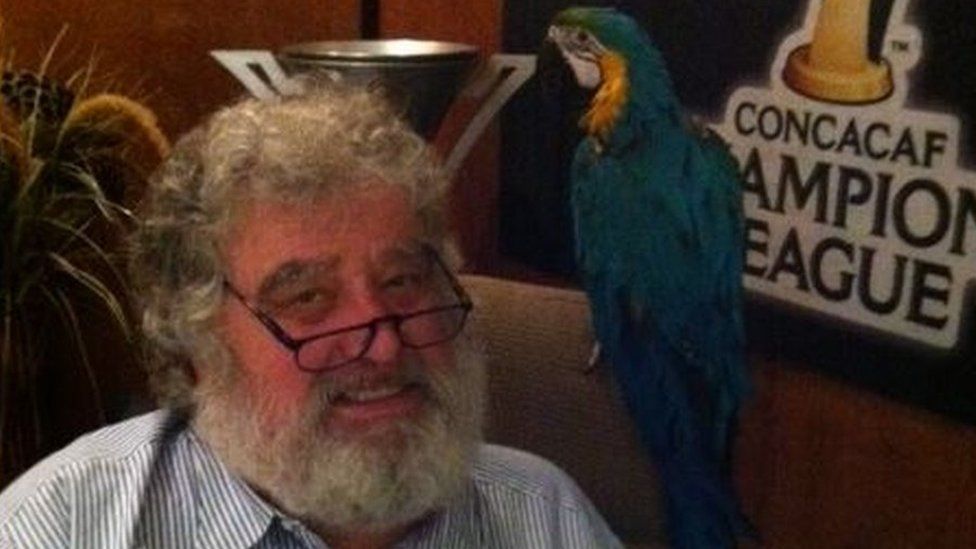 Chuck Blazer sat with pet parrot on his shoulder